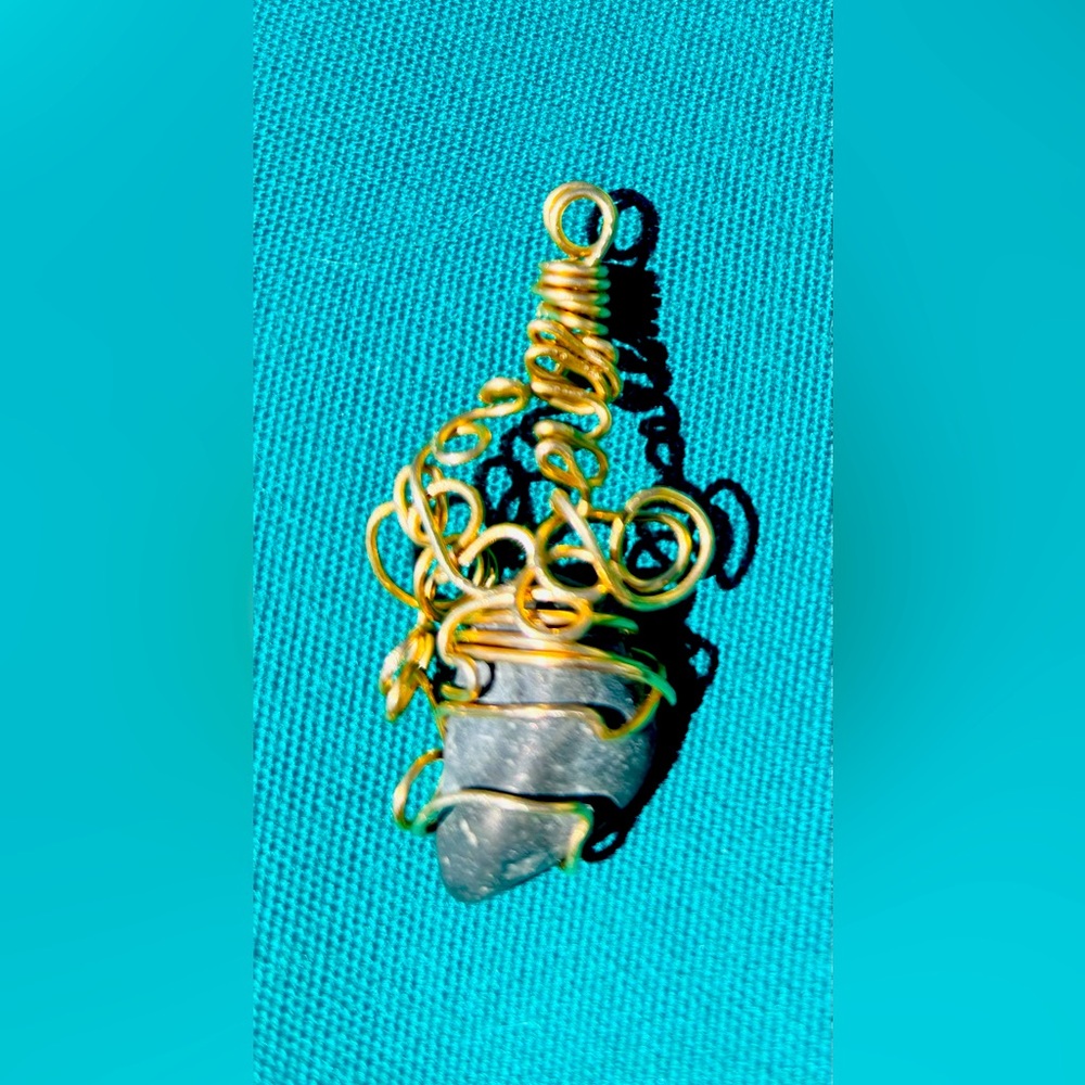 Copper wire wrapped natural finger lakes lucky stone pendant.